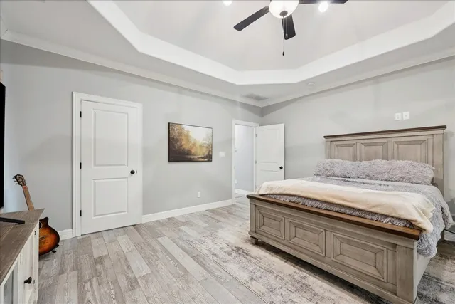 a bedroom with a bed and a chandelier