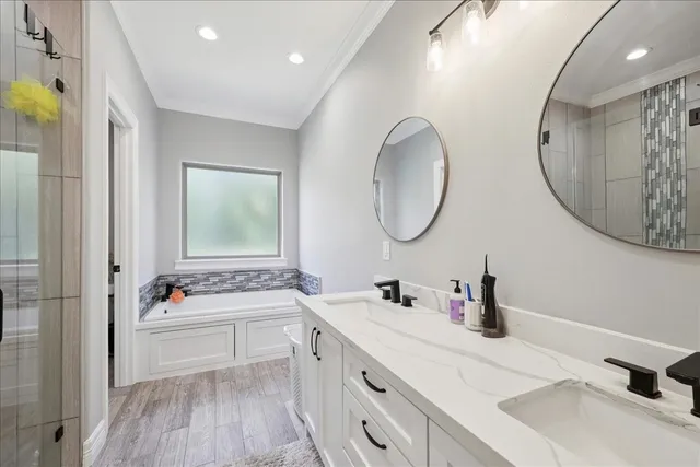 a bathroom with a double vanity sink mirror and shower