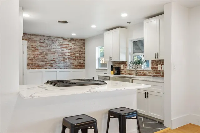 a view of a kitchen with cabinets and stainless steel appliances
