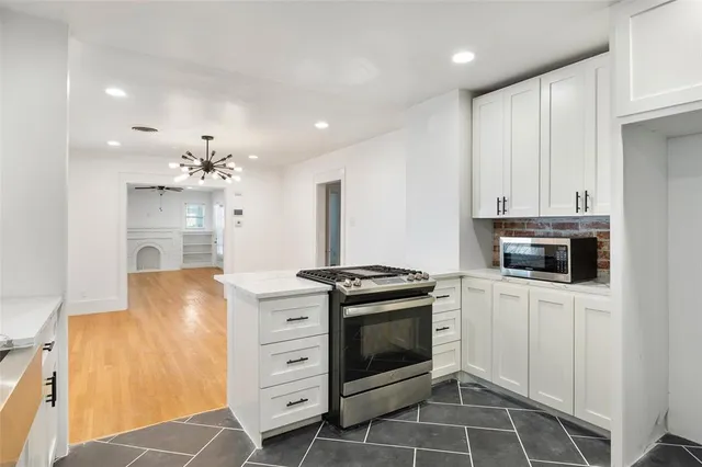 a kitchen with stainless steel appliances a stove sink and cabinets