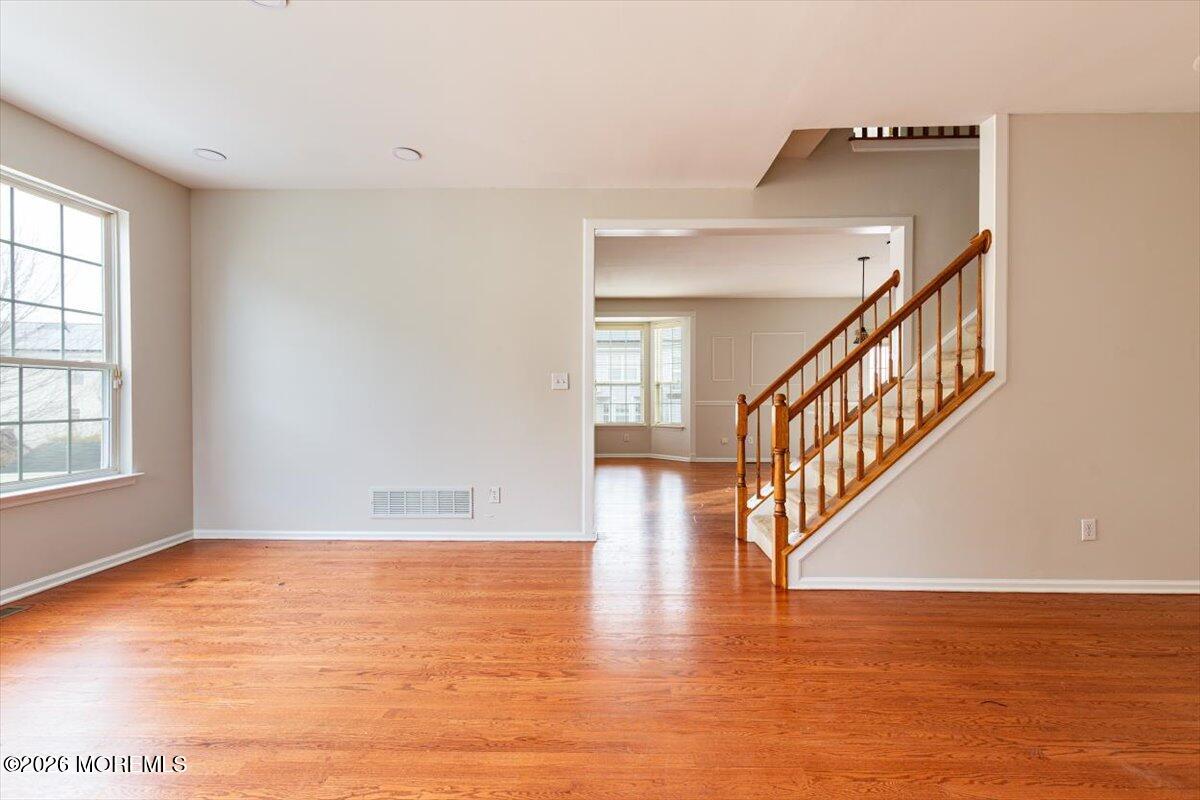 10 Hemingway Lane Columbus, NJ 08022 - Photo 17 of 50 a view of an empty room with wooden floor and a window