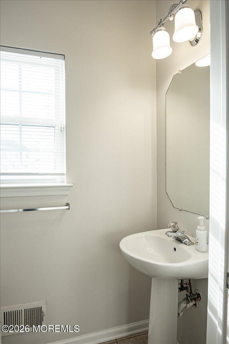 10 Hemingway Lane Columbus, NJ 08022 - Photo 20 of 50 a bathroom with a sink a mirror and a window