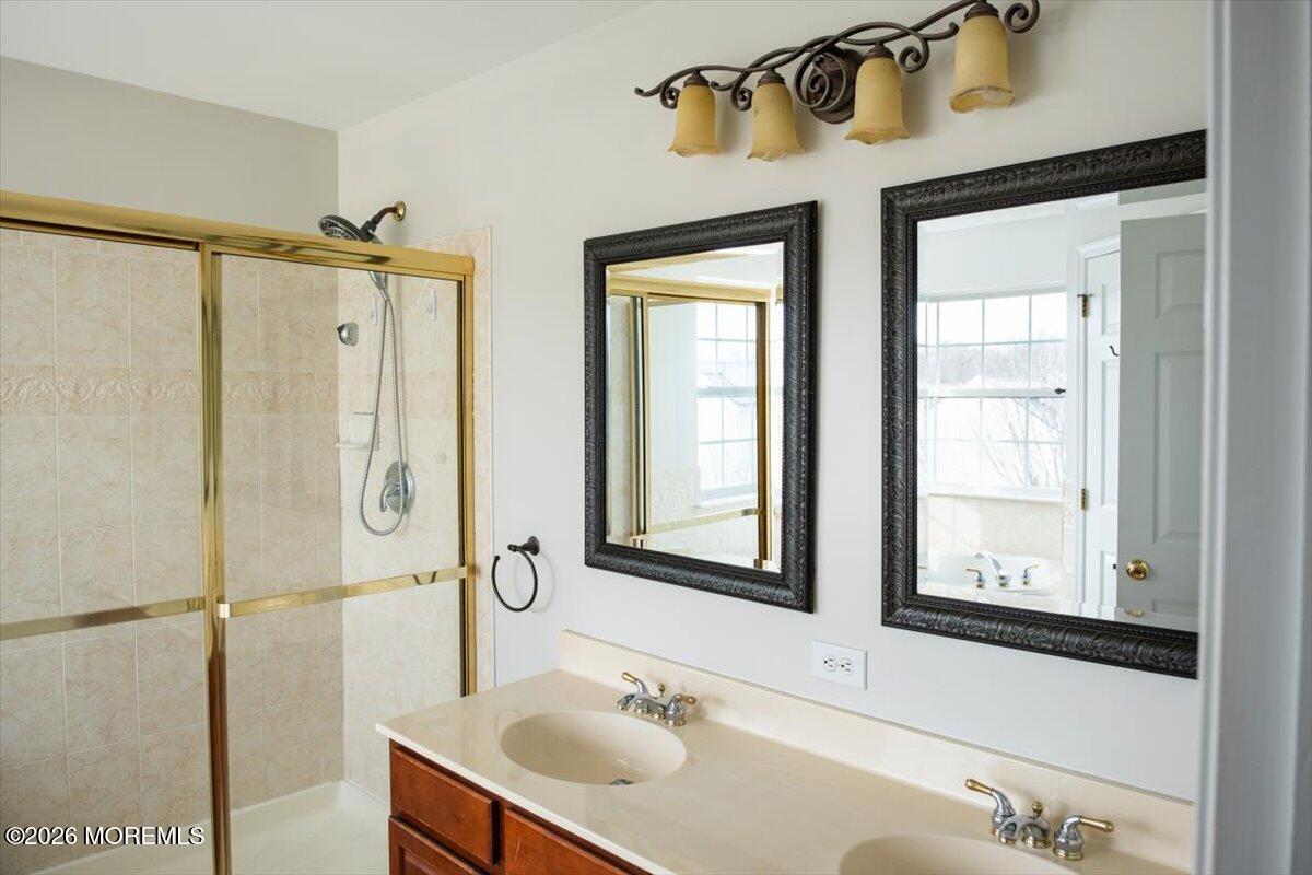 10 Hemingway Lane Columbus, NJ 08022 - Photo 26 of 50 a bathroom with a shower sink and mirror