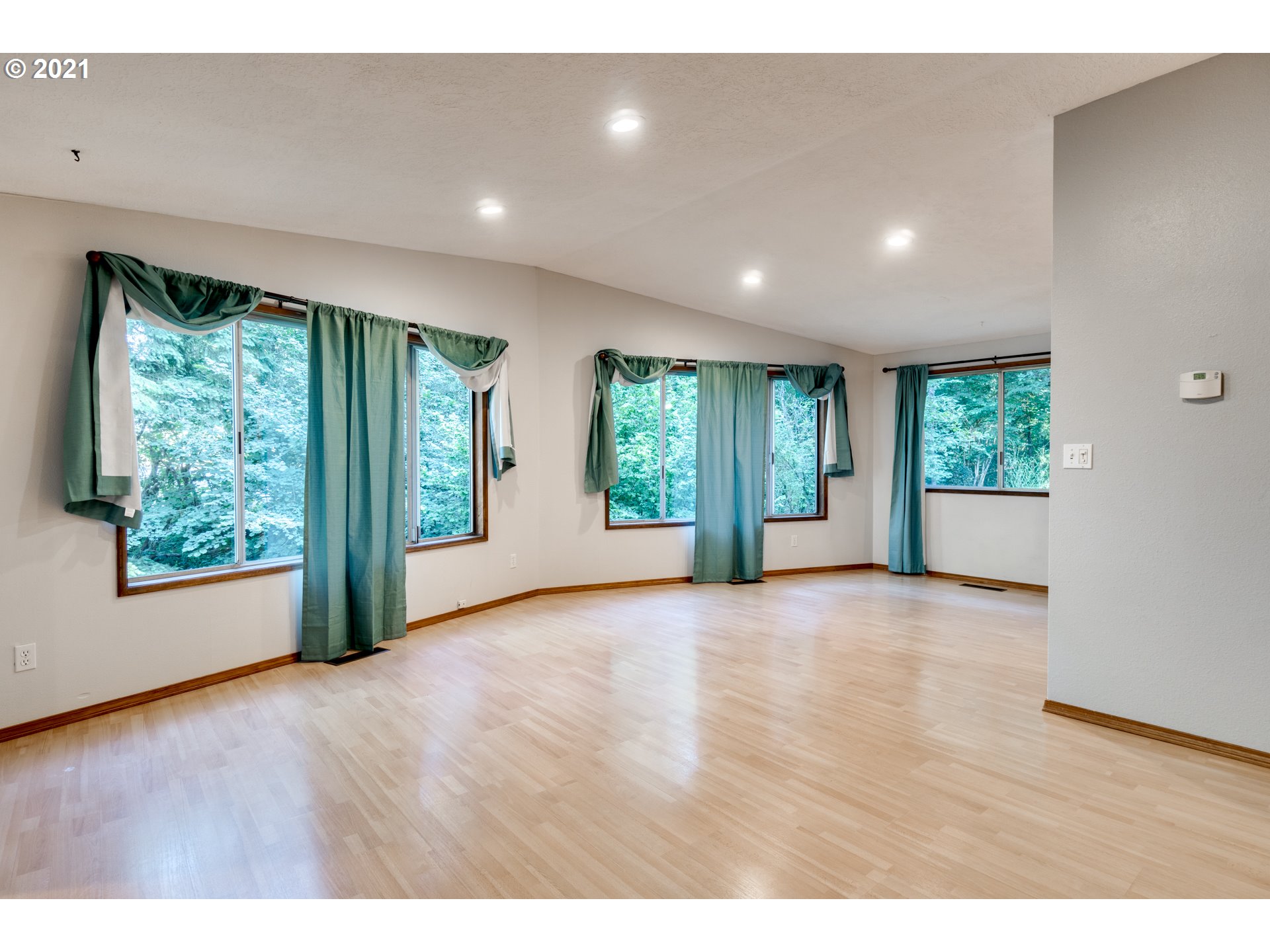 531 Oak Point Road Longview, WA 98632 - Photo 6 of 29 a view of an empty room with wooden floor and windows