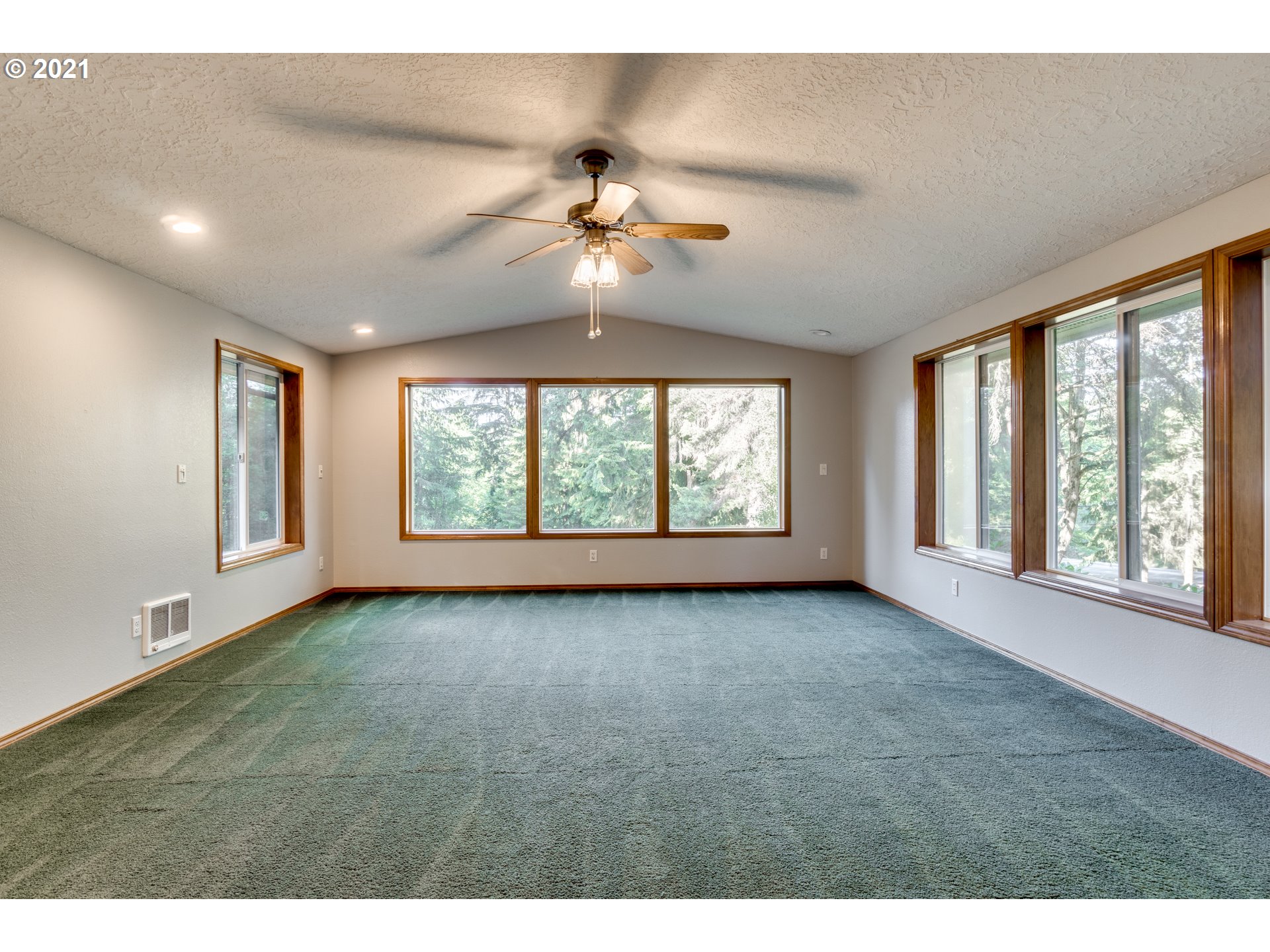 531 Oak Point Road Longview, WA 98632 - Photo 8 of 29 a view of an empty room with chandelier fan and fire place