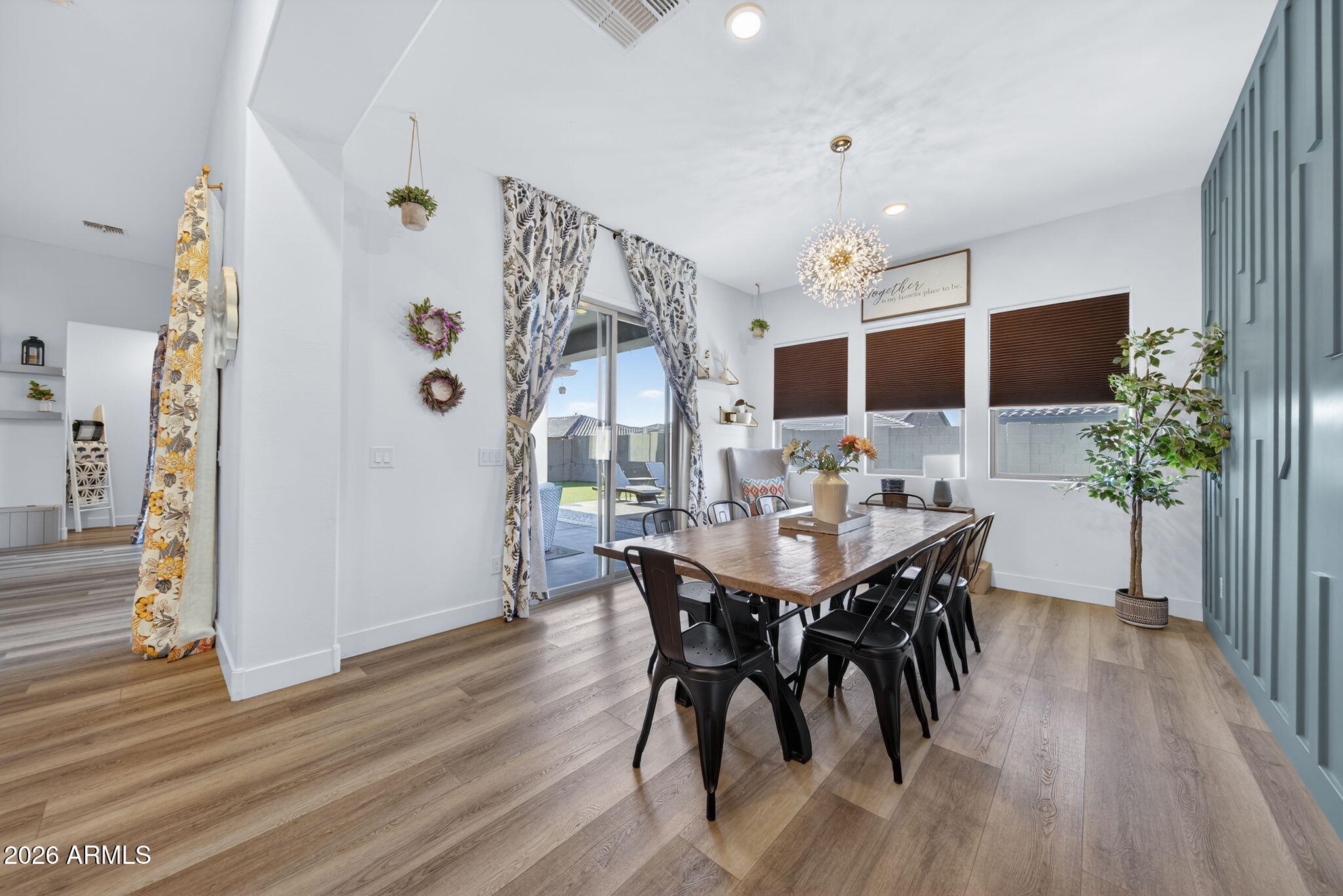 9932 East Rotation Drive Mesa, AZ 85212 - Photo 13 of 62 a view of a dining room with furniture and wooden floor