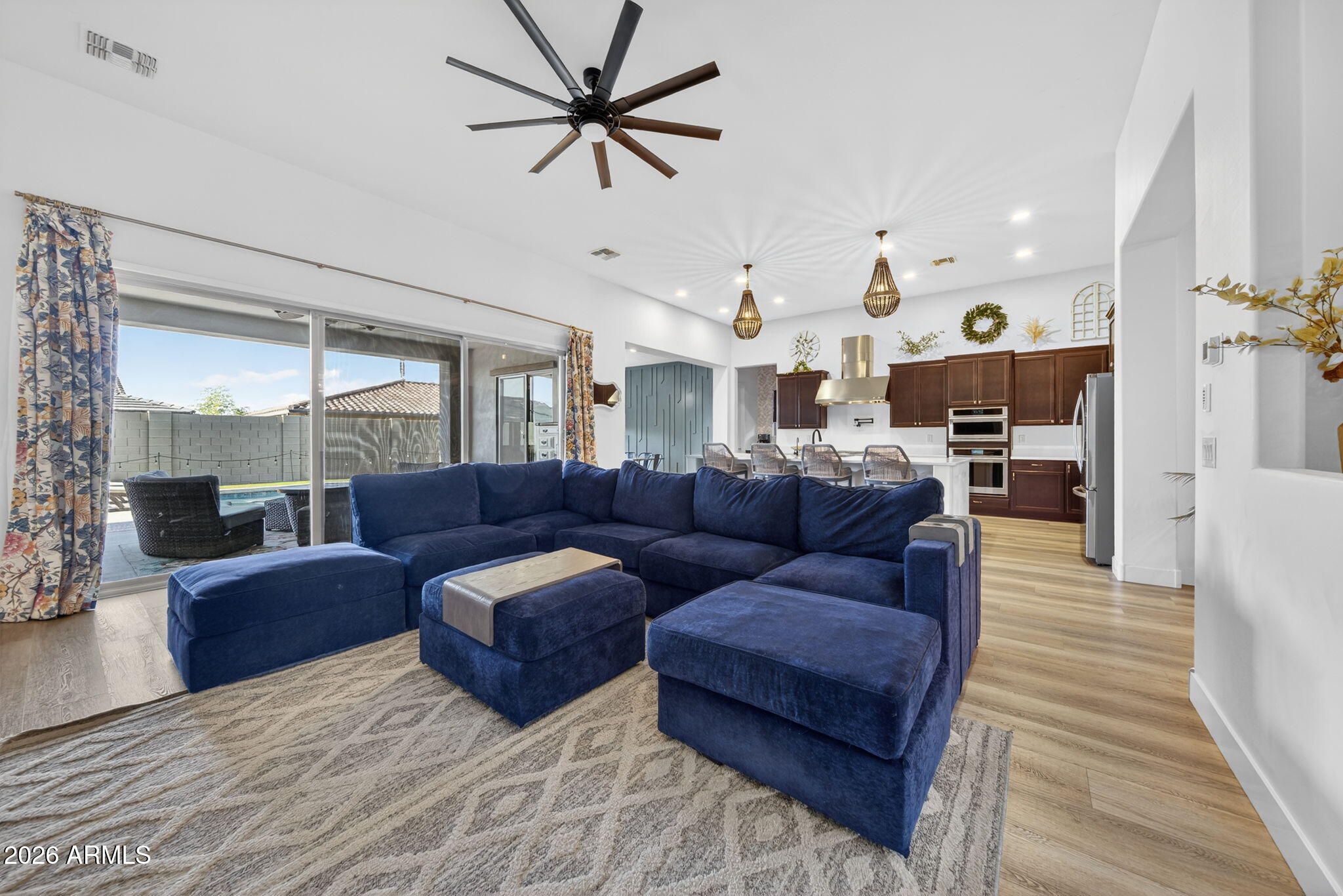 9932 East Rotation Drive Mesa, AZ 85212 - Photo 16 of 62 a living room with furniture kitchen view and a wooden floor