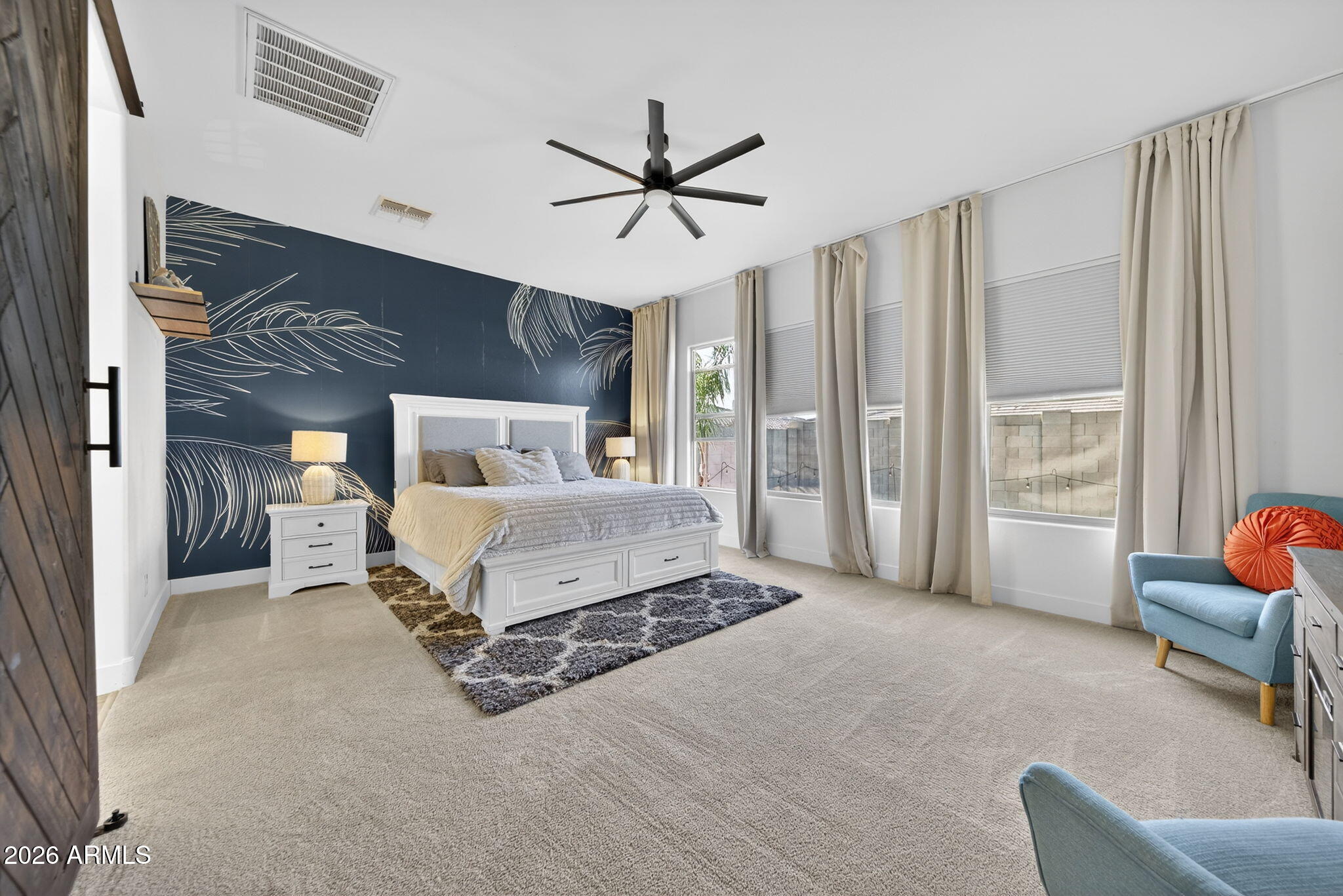 9932 East Rotation Drive Mesa, AZ 85212 - Photo 21 of 62 a spacious bedroom with a bed and a couch