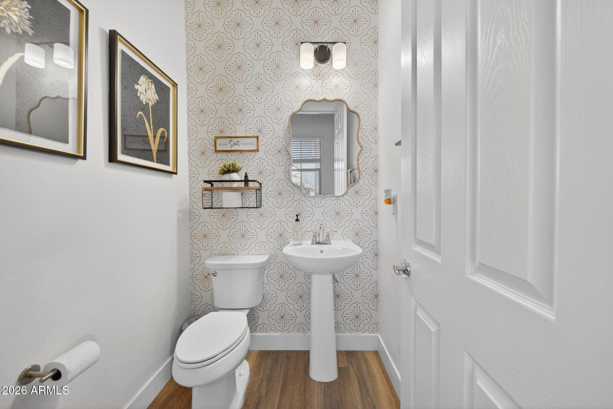9932 East Rotation Drive Mesa, AZ 85212 - Photo 44 of 62 a bathroom with a toilet a sink and mirror