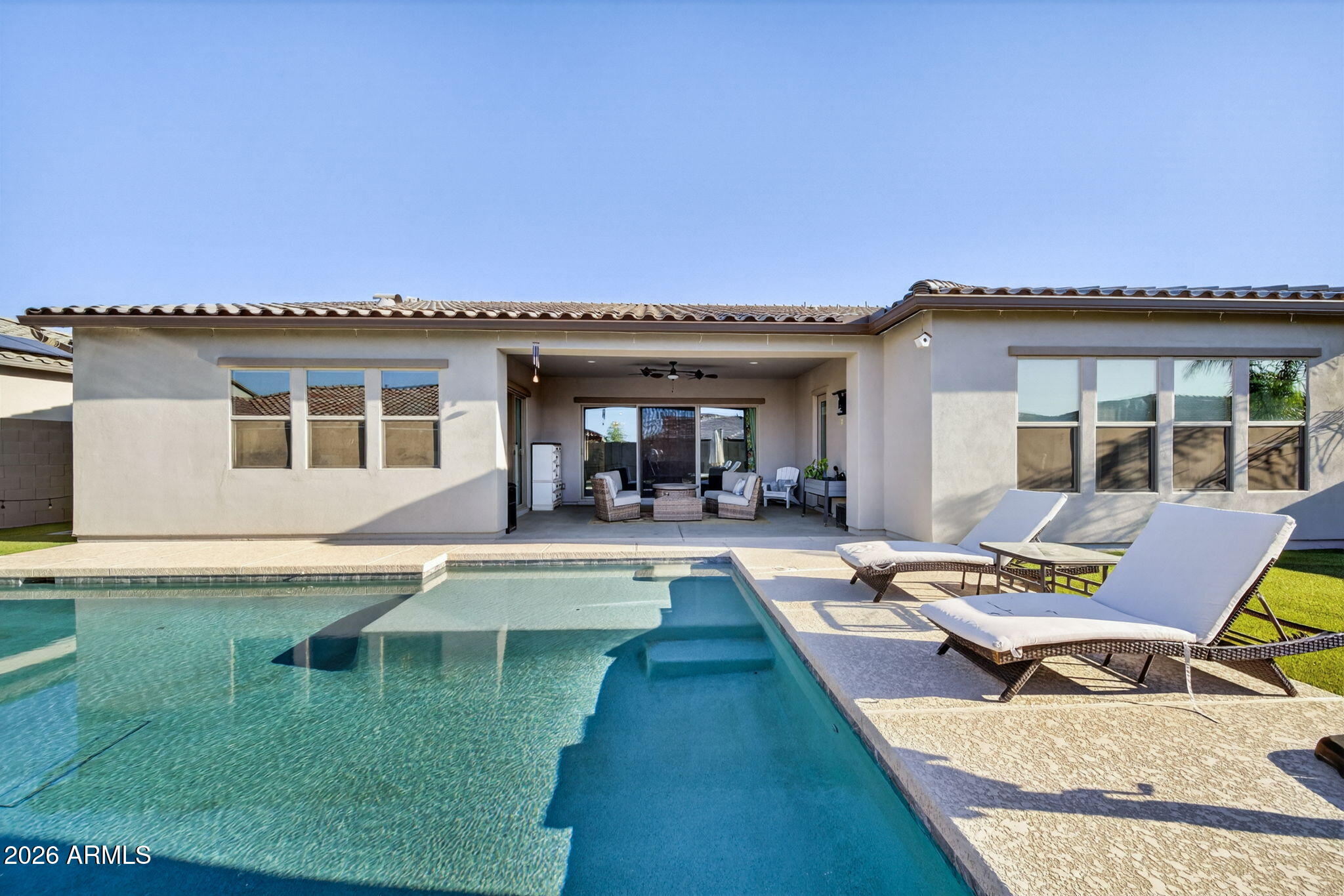 9932 East Rotation Drive Mesa, AZ 85212 - Photo 58 of 62 a view of a patio with dining table and chairs with wooden floor and fence
