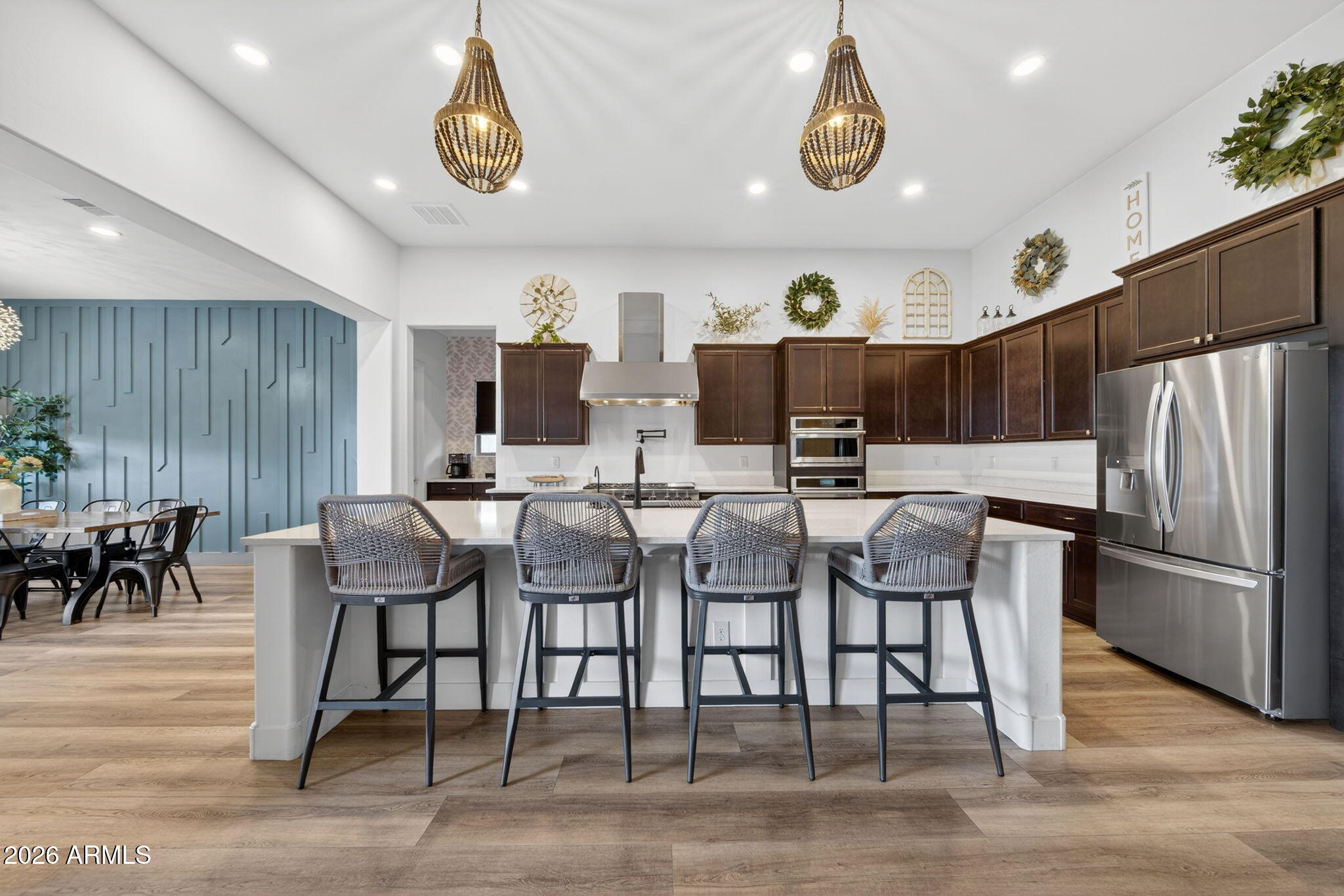 9932 East Rotation Drive Mesa, AZ 85212 - Photo 7 of 62 a dining room with stainless steel appliances kitchen island granite countertop a table chairs and a microwave