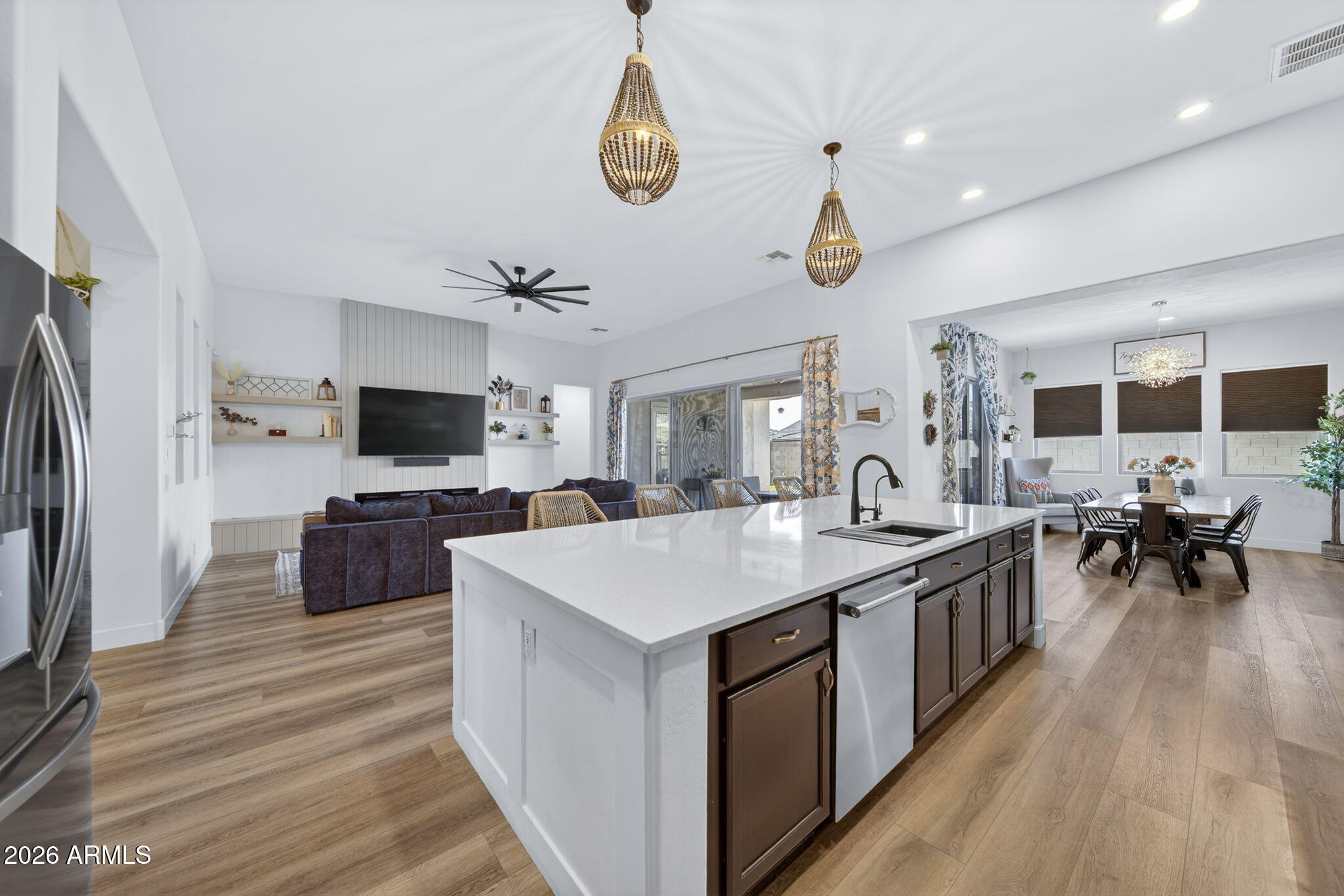 9932 East Rotation Drive Mesa, AZ 85212 - Photo 10 of 62 a large kitchen with stainless steel appliances a stove center island a dining table and chairs