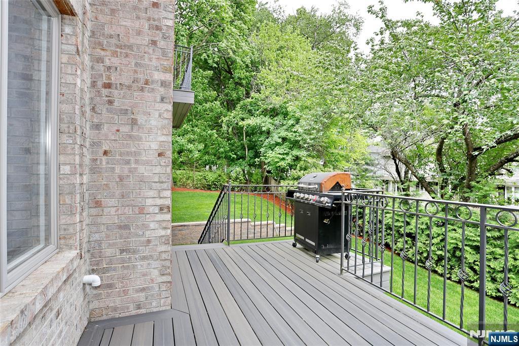 65 Ross Avenue Demarest, NJ 07627 - Photo 17 of 48 a view of a balcony with two couches and wooden floor