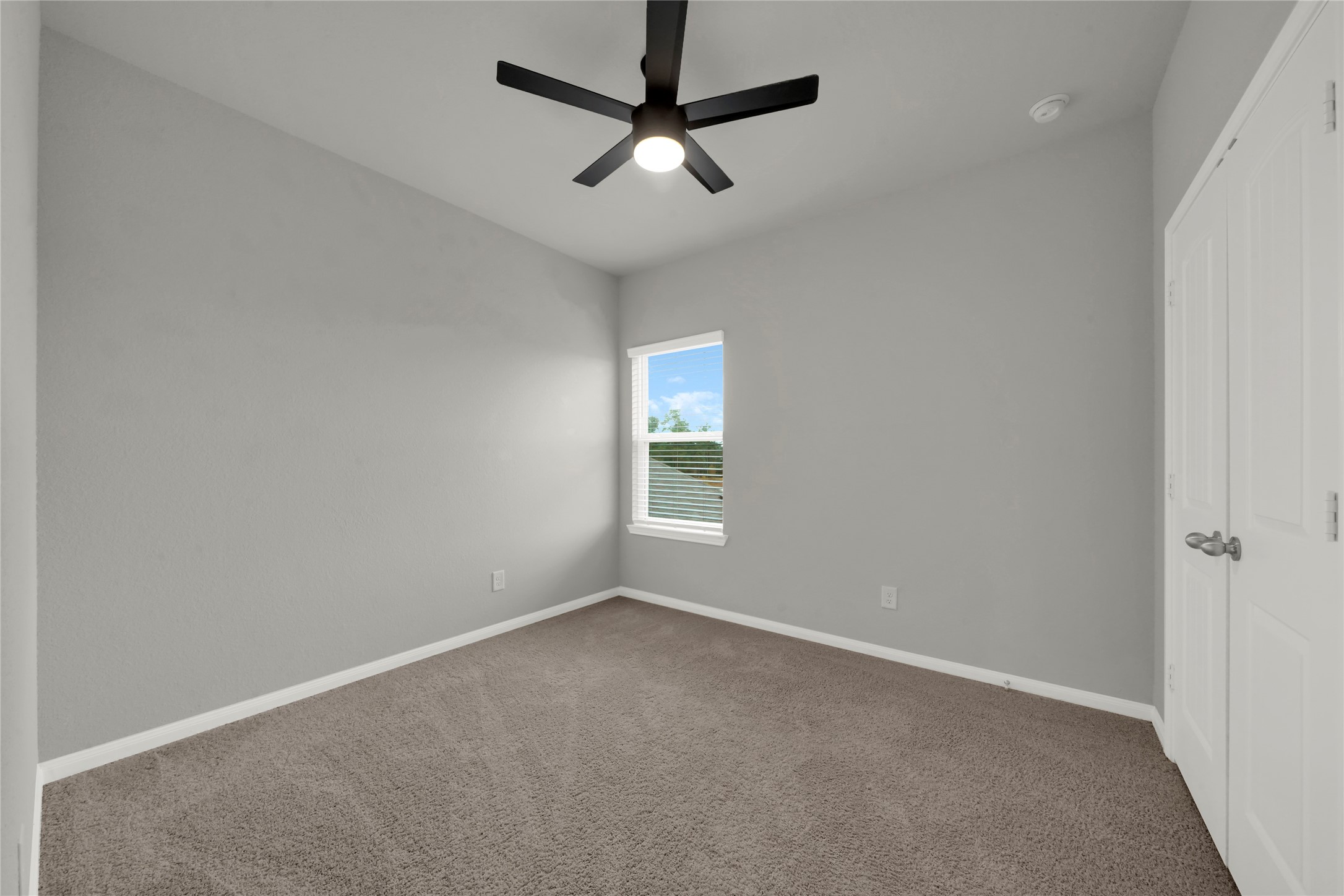 2542 Steelhead Drive Conroe, TX 77384 - Photo 10 of 20 Bedroom 2 offers a different view. Both rooms include closets.
