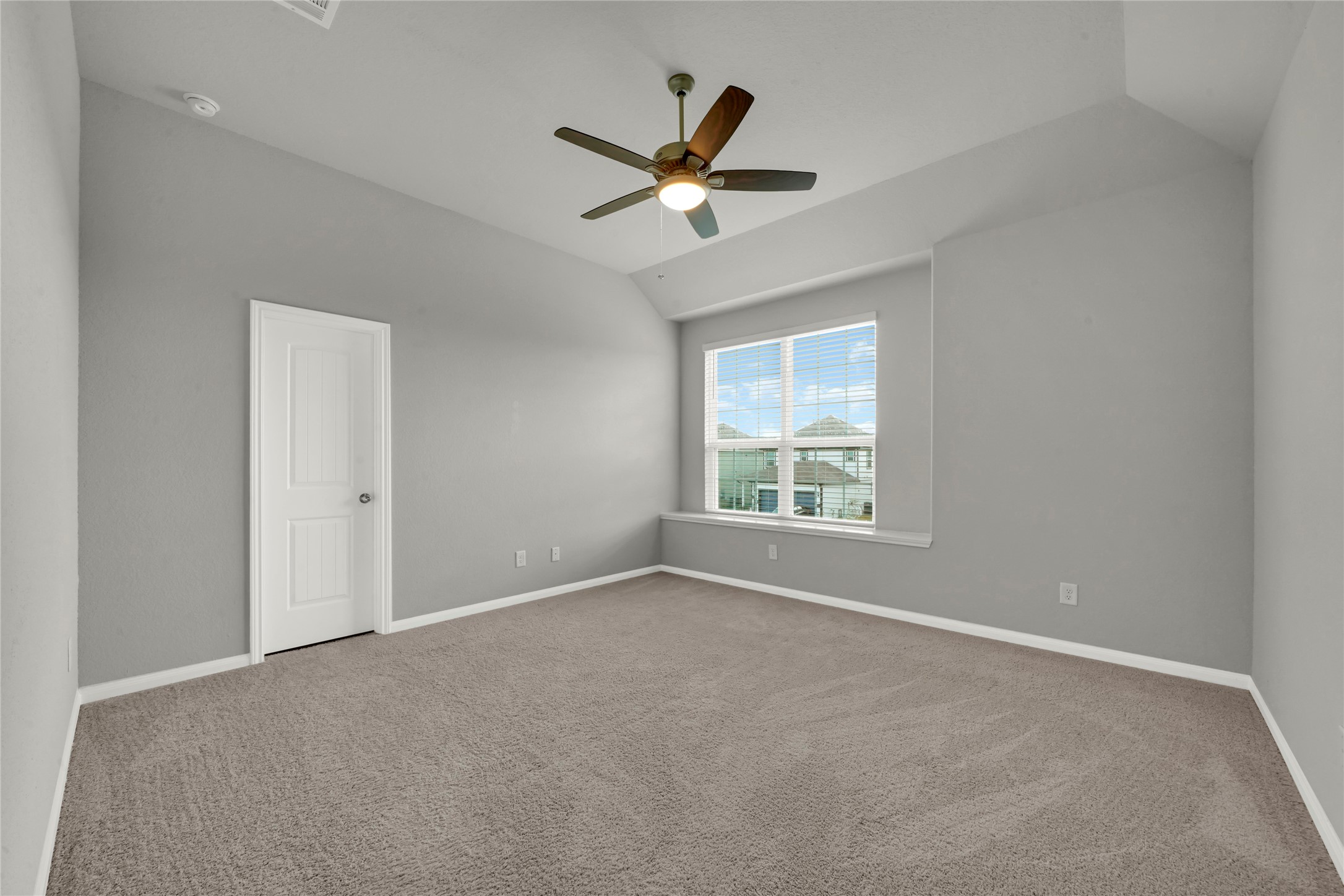 2542 Steelhead Drive Conroe, TX 77384 - Photo 13 of 20 Step inside the primary suite! It rests under a raised ceiling and boasts a sizable window with a view of the neighborhood.