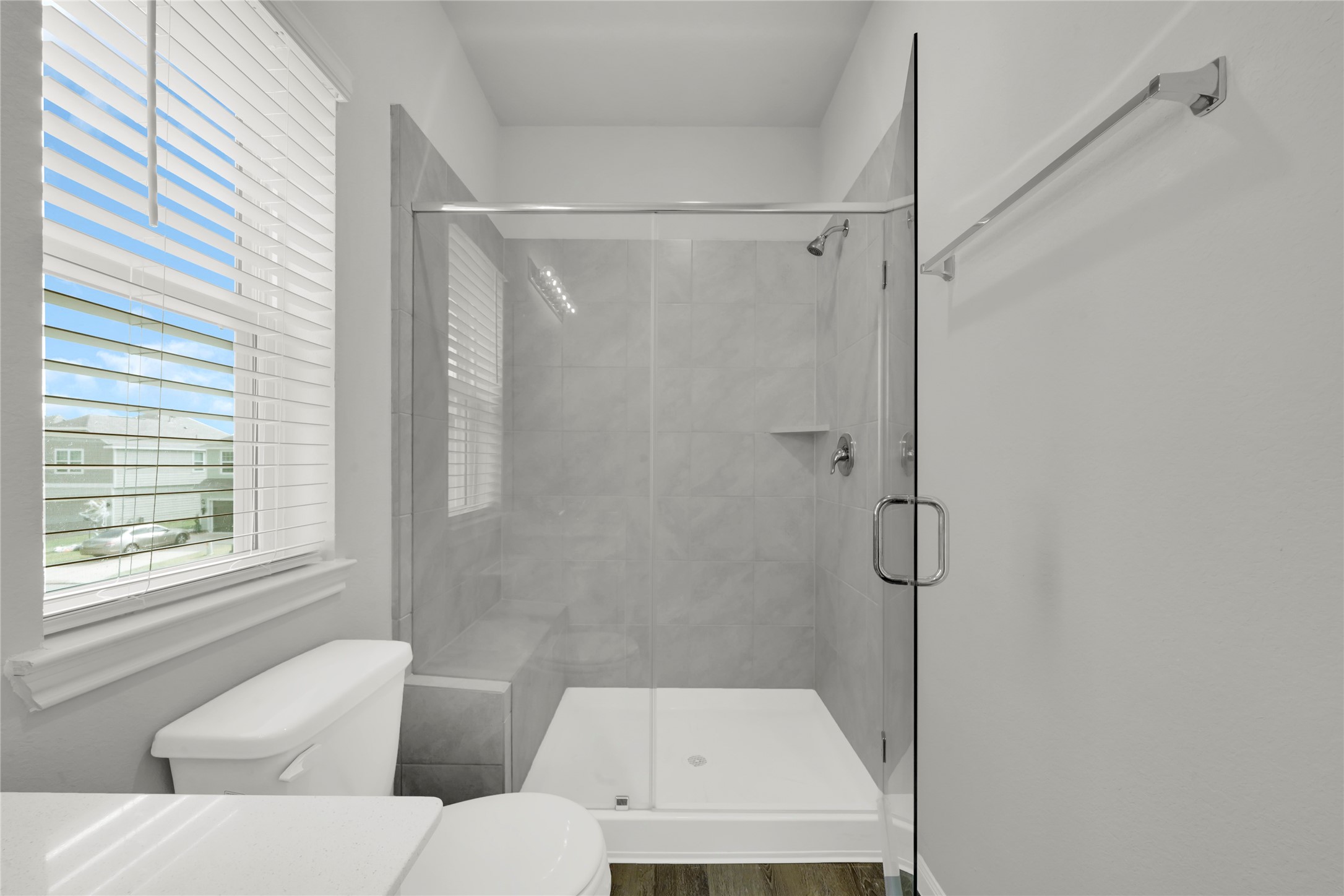 2542 Steelhead Drive Conroe, TX 77384 - Photo 16 of 20 The primary bath also provides a desirable frameless glass shower. Notice the built-in bench for extra convenience.