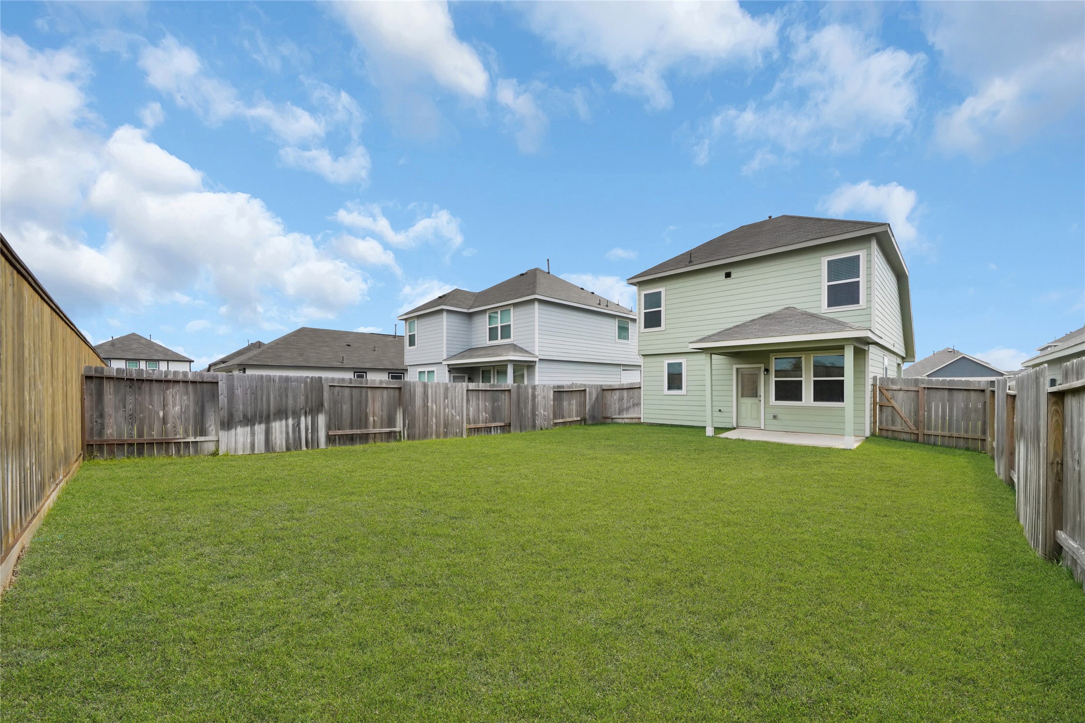 2542 Steelhead Drive Conroe, TX 77384 - Photo 19 of 20 Relax in the shade on your covered back patio overlooking your beautiful yard. Welcome home!