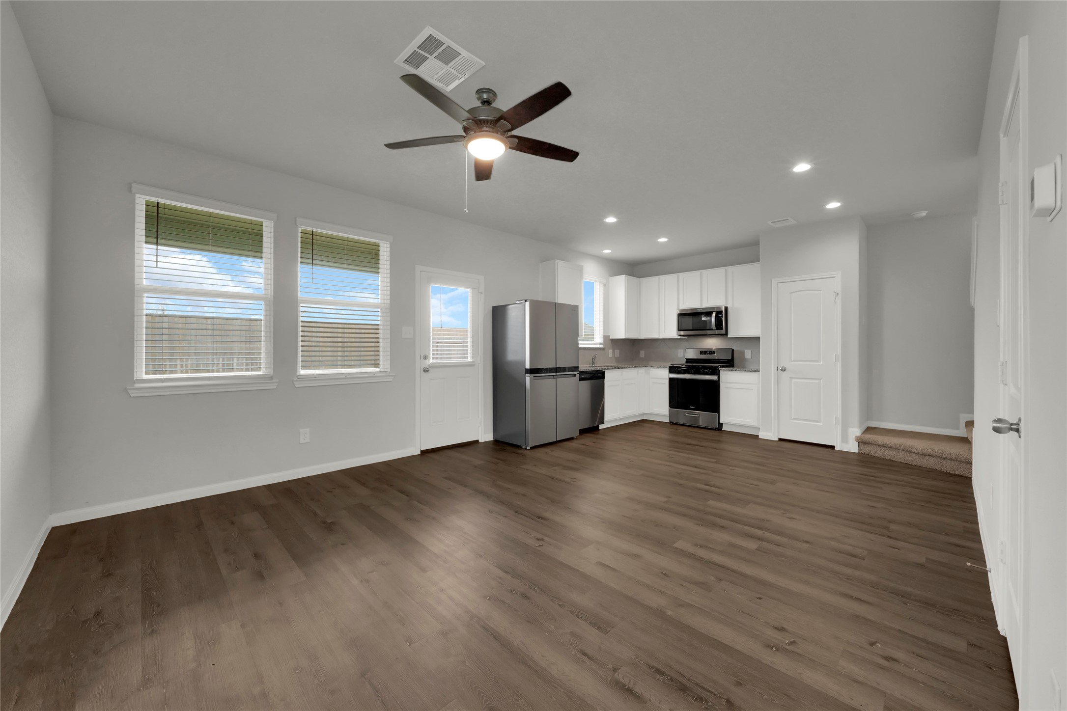 2542 Steelhead Drive Conroe, TX 77384 - Photo 2 of 20 Step inside and note the vinyl plank flooring that joins the living spaces. Plenty of natural light warmly illuminates the space.