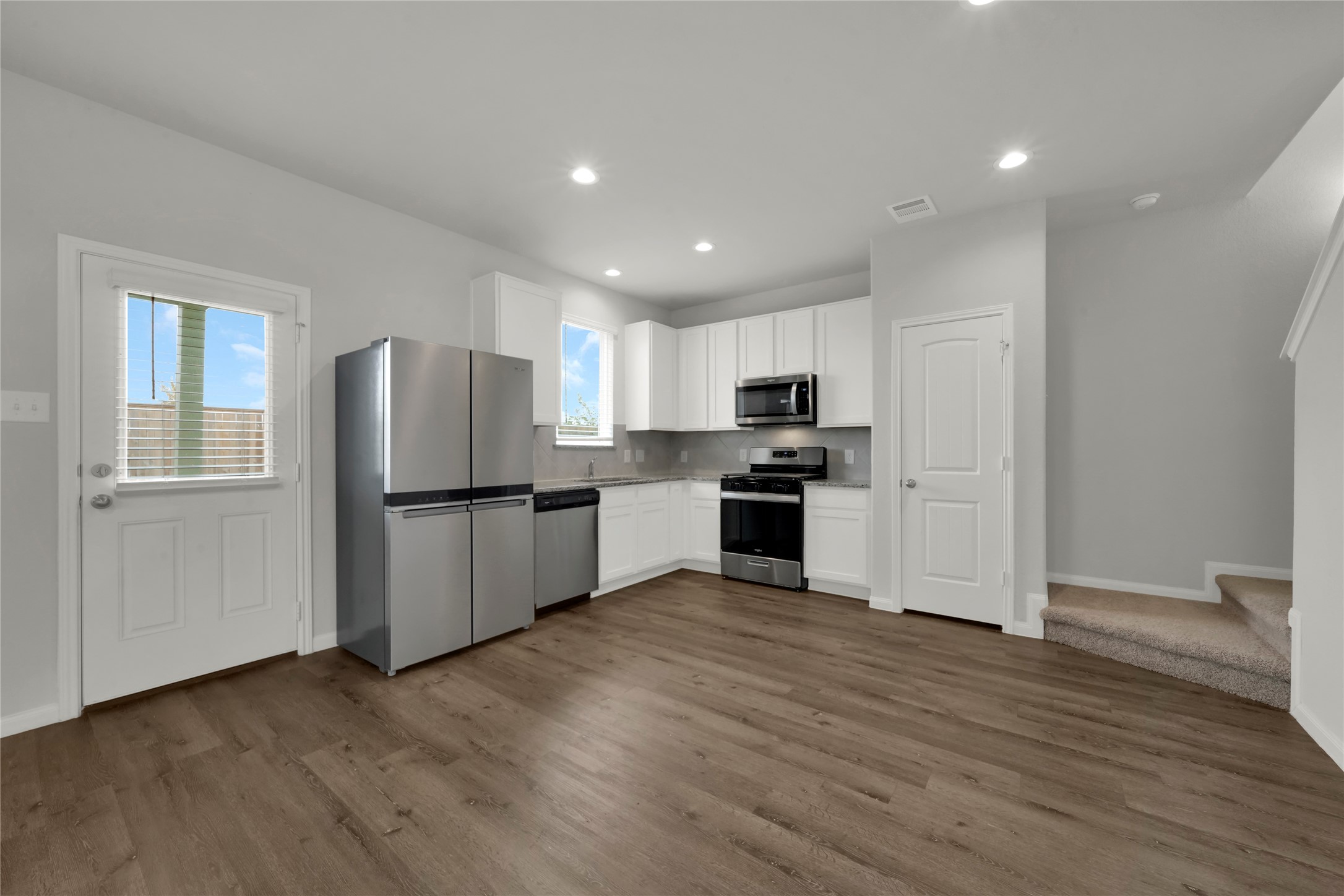 2542 Steelhead Drive Conroe, TX 77384 - Photo 4 of 20 Sleek white cabinets really pop against a neutral granite countertop and tile backsplash. Stainless steel appliances offer the perfect blend and the refrigerator is included.