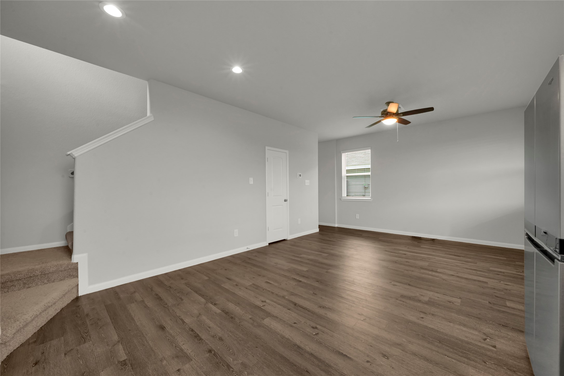 2542 Steelhead Drive Conroe, TX 77384 - Photo 6 of 20 From the kitchen, overlooking the living room and dining room combo. The stairs on the left will lead the way to 3 bedrooms and 2 full baths.