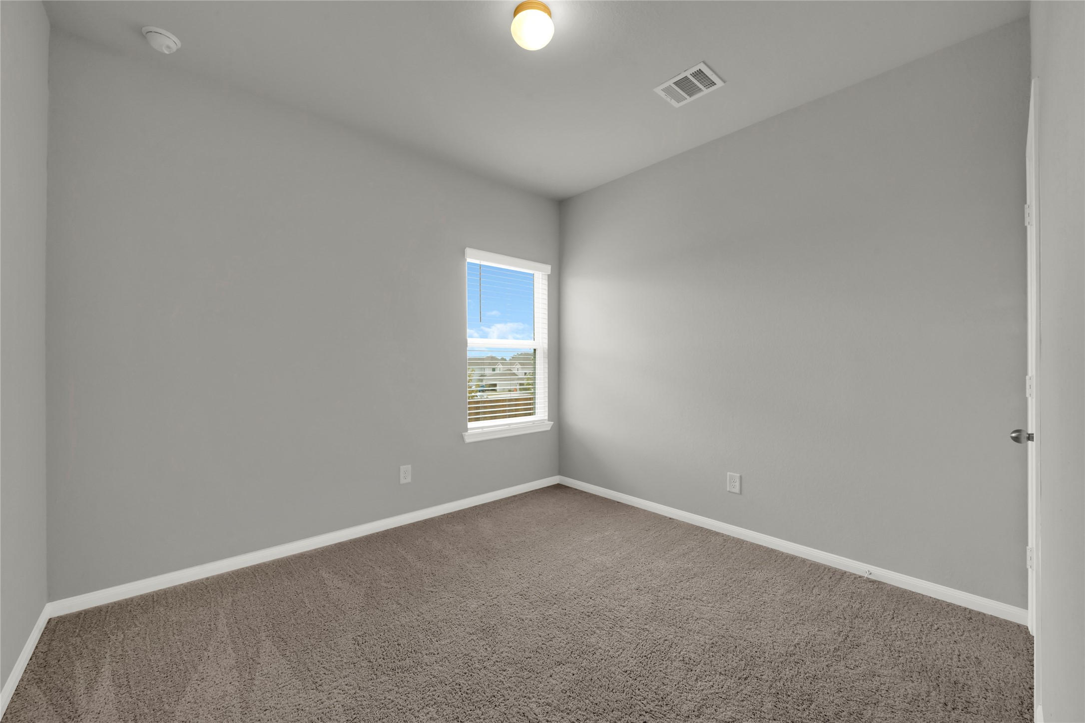 2542 Steelhead Drive Conroe, TX 77384 - Photo 9 of 20 Bedroom 1 boasts a corner window with a view of the neighborhood.