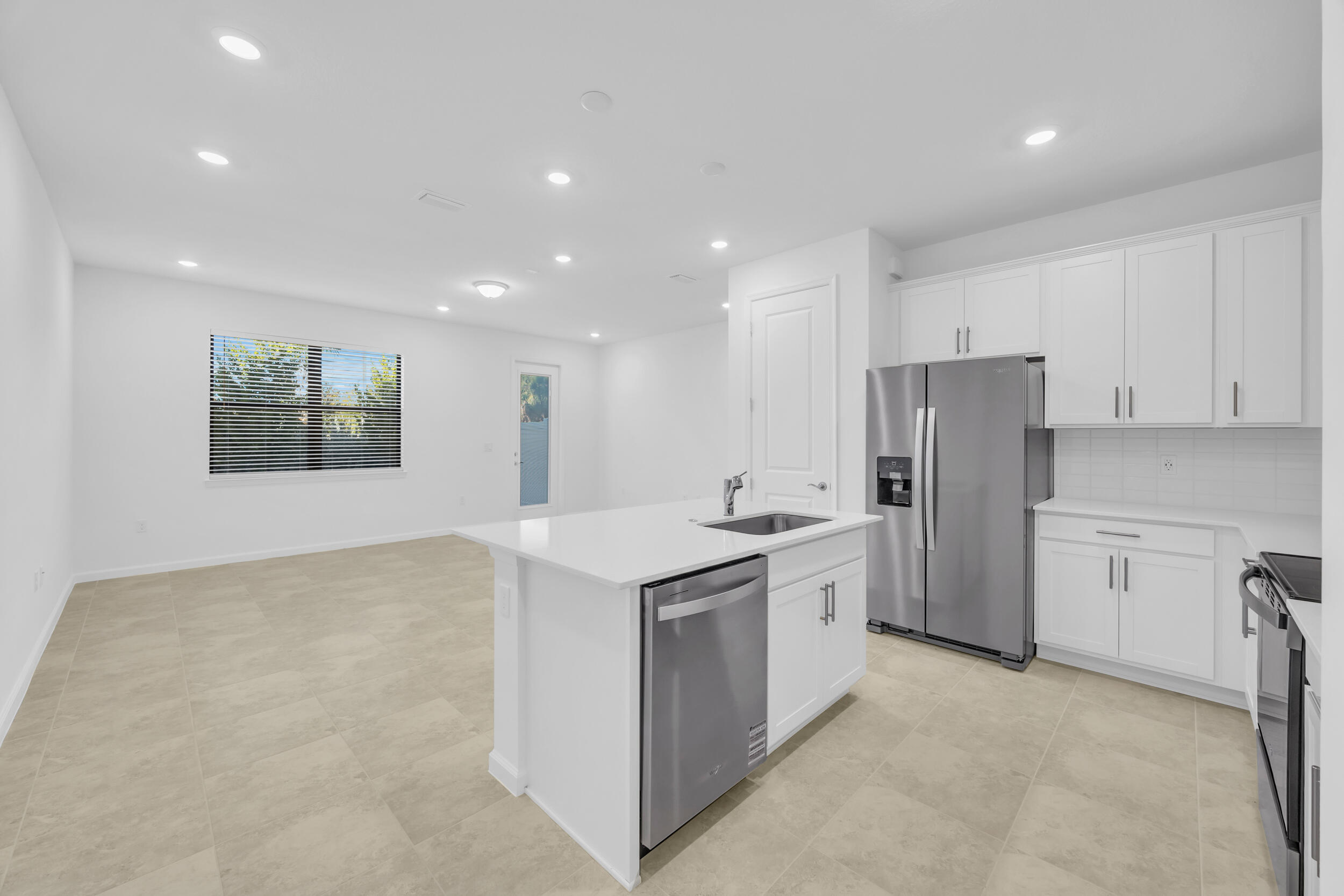 a kitchen with refrigerator and cabinets