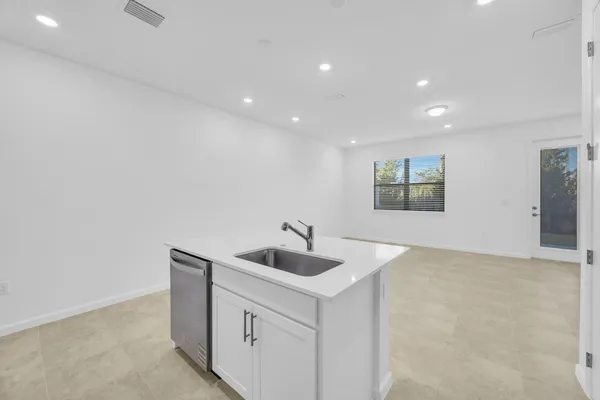 a kitchen with a sink stove and refrigerator