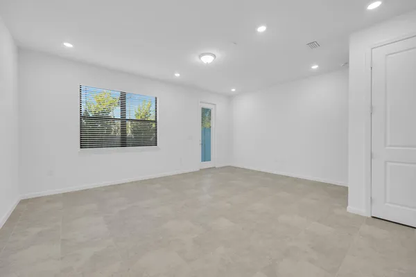an empty room with windows and closet