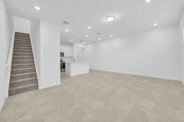 an empty room with windows and closet