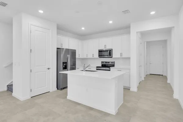 a view of kitchen with stainless steel appliances cabinets