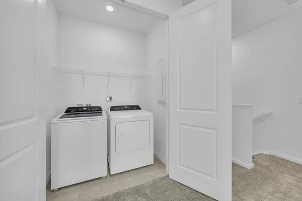 a backyard of a house with plants and wooden fence