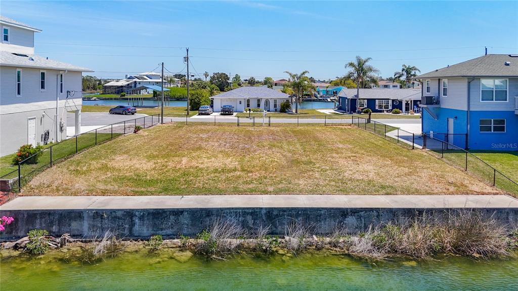 3377 Oleander Drive Hernando Beach, FL 34607 - Photo 7 of 22 a view of a swimming pool with a yard and sitting area
