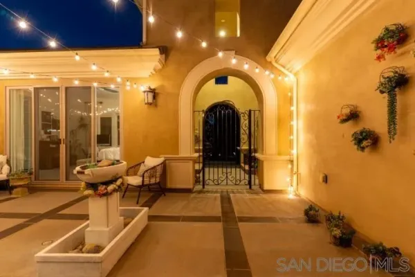 a view of a room with wooden floor windows and a chandelier