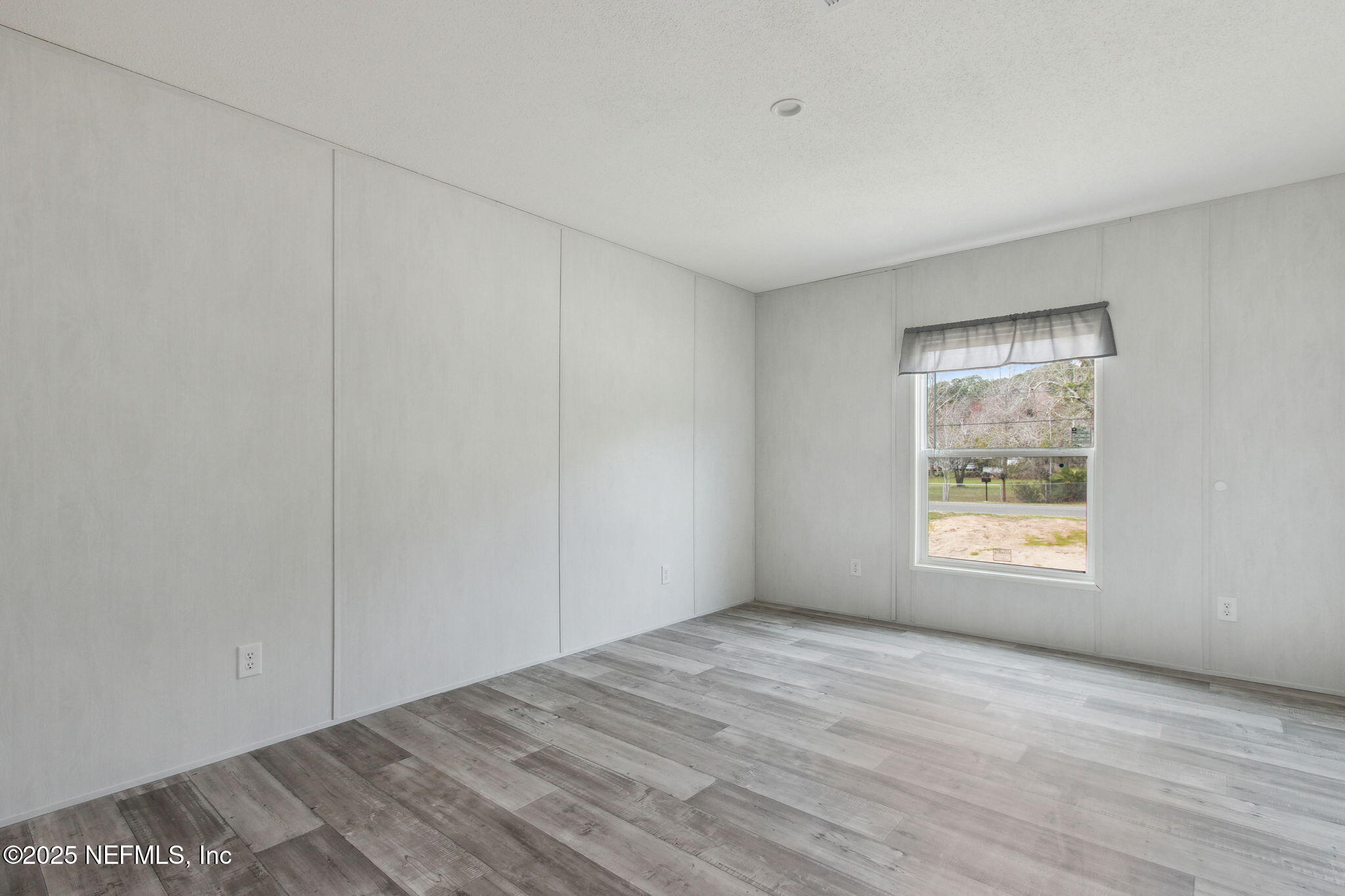 87454 Haven Road Yulee, FL 32097 - Photo 26 of 38 a view of an empty room with a window and closet area
