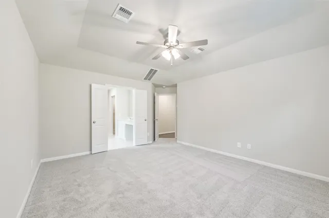 a spacious bathroom with a shower sink and mirror