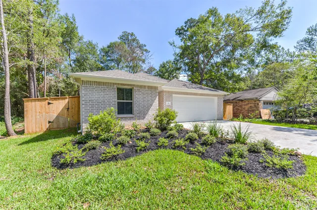 a view of a house with a yard and a garden