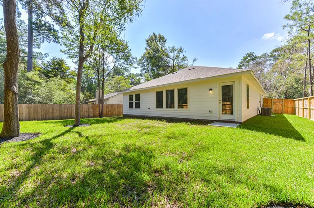 a front view of a house with yard and green space
