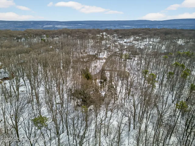 a view of a house with wooden fence