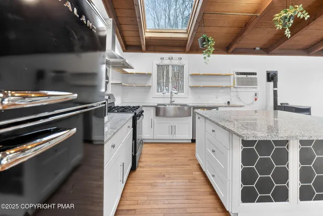 a kitchen with stainless steel appliances granite countertop a stove and a sink