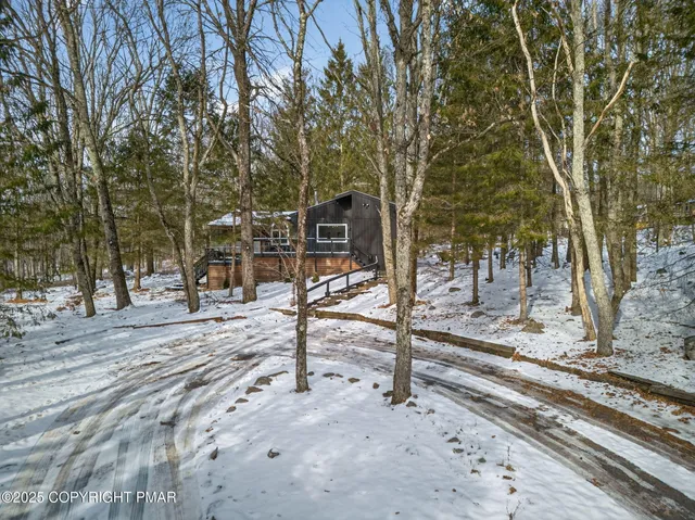 a kitchen with stainless steel appliances granite countertop a wooden floors a stove and a refrigerator