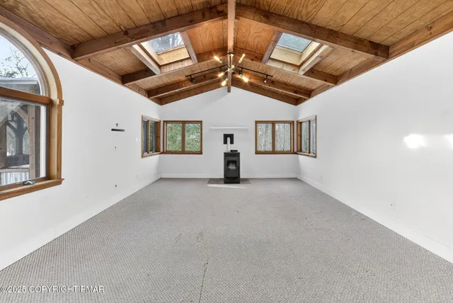 a view of a livingroom with a ceiling fan and window