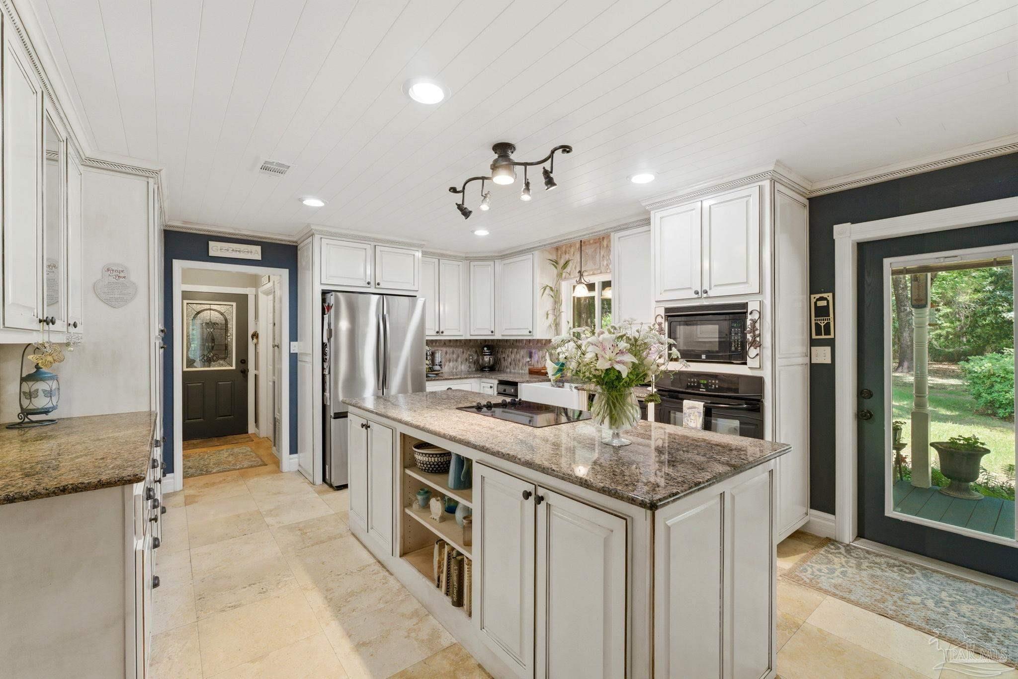 6930 Summit Way Milton, FL 32570 - Photo 18 of 71 a kitchen with stainless steel appliances granite countertop a sink stove and refrigerator