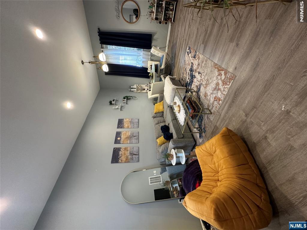128 Locust Avenue, Unit D Wallington, NJ 07057 - Photo 2 of 8 a living room with furniture kitchen view and a wooden floor