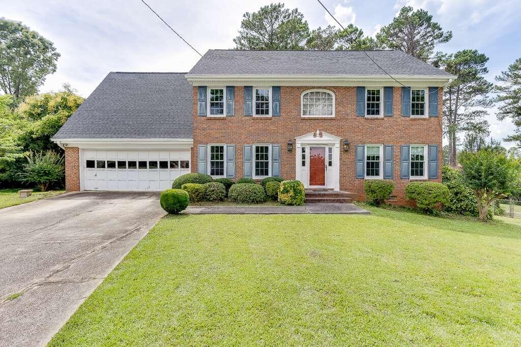 a front view of a house with garden