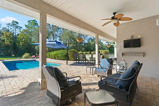 a bedroom with a bed a dresser and potted plant