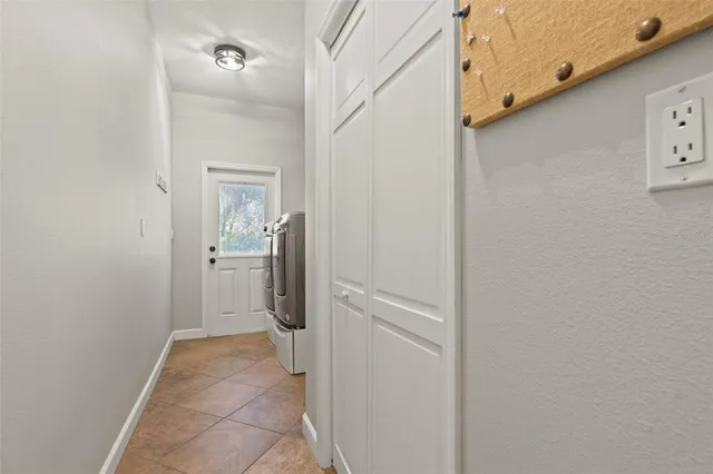 a living room with furniture a flat screen tv and kitchen view