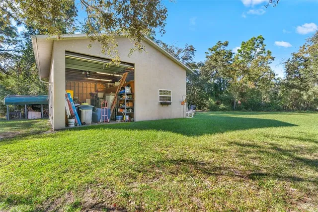 a backyard of a house with table and chairs