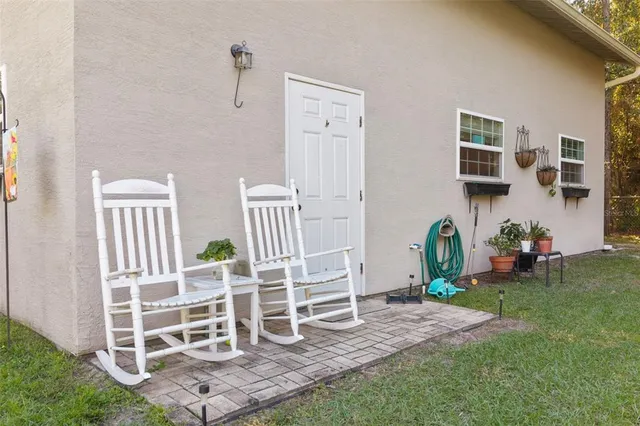 an aerial view of a house with a yard and lake view