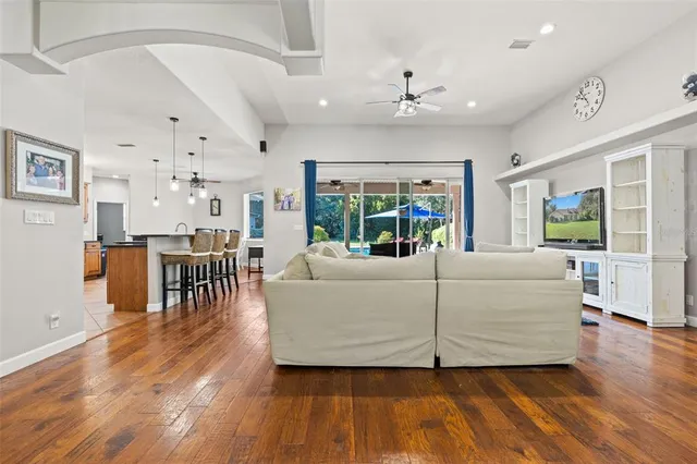 a living room with furniture and a wooden floor