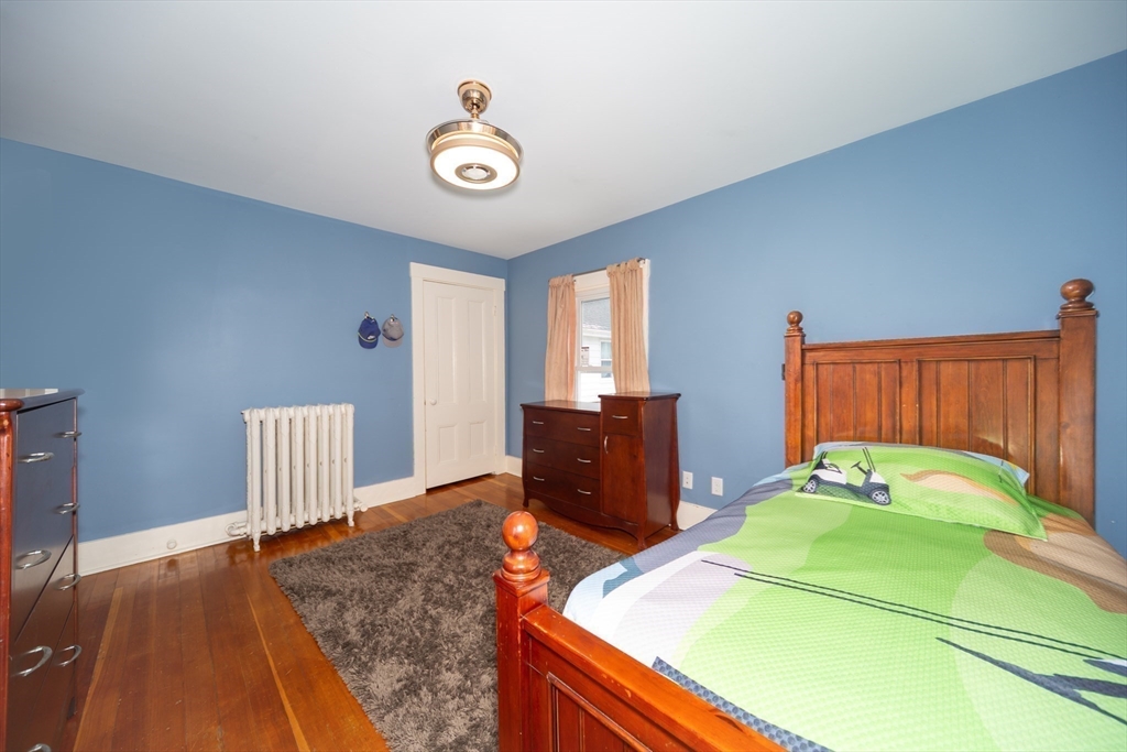 13 Union Street, Unit 13 Needham, MA 02494 - Photo 11 of 19 a bedroom with a bed and wooden floor